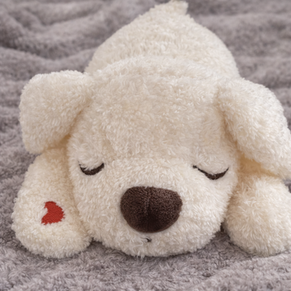 Hug Me Dogs plush dog toy with a brown nose and red heart on a gray blanket